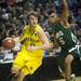 Michigan senior Zack Novak moves the ball around Ohio University junior D.J. Cooper in the first half of the second round of the NCAA tournament at Bridgestone Arena in Nashville, Tenn.  Melanie Maxwell I AnnArbor.com